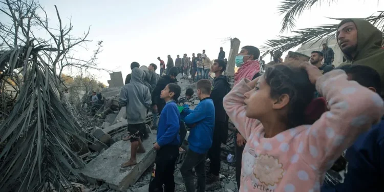 Palestinians search for bodies and survivors after Israeli air strikes in southern Gaza on Tuesday