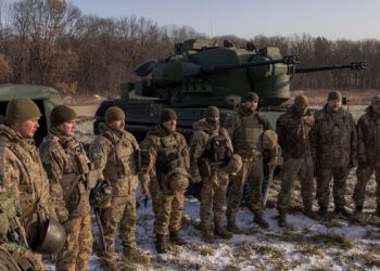 Ukrainian servicemen of a drone hunting team gather next to German Gepard anti-aircraft-gun tank that is used to target Russian launched drones, in the outskirts of Kyiv,