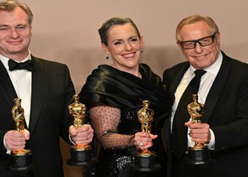 British film producer Emma Thomas, US film producer Charles Roven, and British filmmaker Christopher Nolan (also Best Director) pose in the press room with the Oscar for Best Picture for “Oppenheimer” during the 96th Annual Academy Awards at the Dolby Theatre in Hollywood, California on March 10, 2024.
