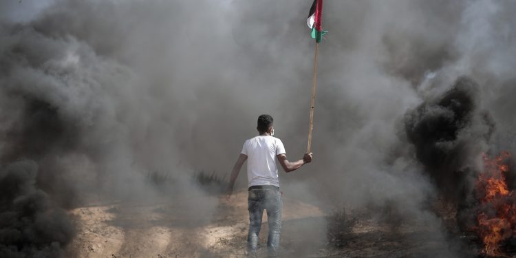 A man waving a Palestinian flag