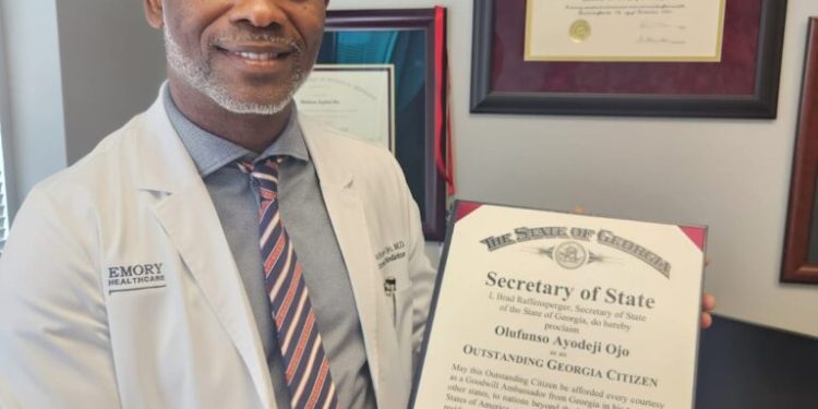 Physician Dr Olufunso Ojo displaying his award
