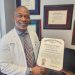 Physician Dr Olufunso Ojo displaying his award