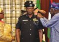 President Bola Tinubu decorating Disu as new IGP on