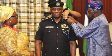 President Bola Tinubu decorating Disu as new IGP on March 4, 2026.