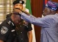President Bola Ahmed Tinubu decorating AIG Tunji Disu during a ceremony at the Presidential Office in State House, Abuja