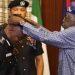 President Bola Ahmed Tinubu decorating AIG Tunji Disu during a ceremony at the Presidential Office in State House, Abuja