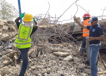 Rescue workers at the site of the building collapse