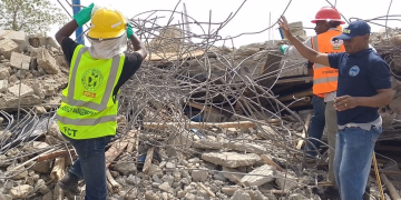 Rescue workers at the site of the building collapse
