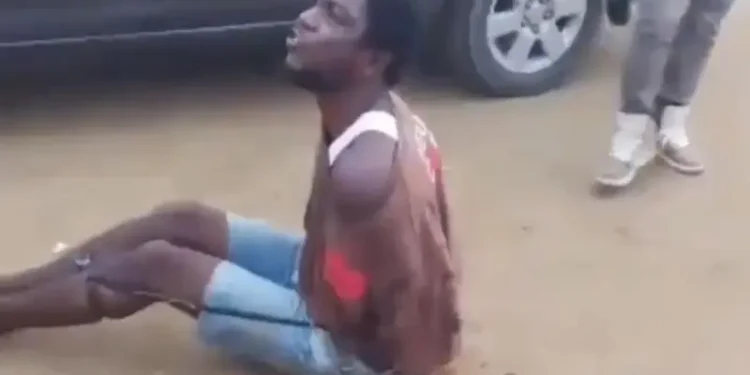 The restrained suspect begging the police officer