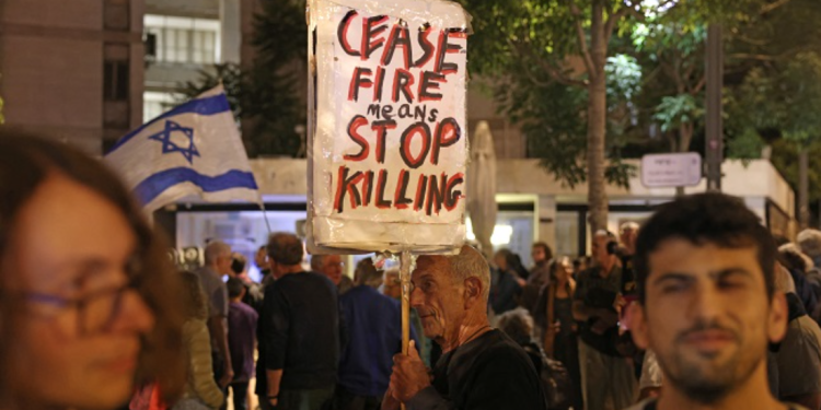 Israeli left-wing activists demonstrate against the Israeli government outside the Prime Minister’s residence in Jerusalem on Sunday