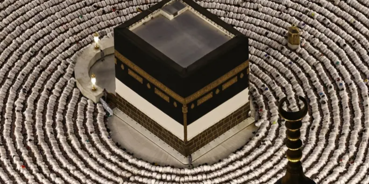 Muslims perform the evening prayer around the Kaaba, Islam's holiest shrine, at Grand Mosque complex on May 24, 2026, ahead of the annual Hajj pilgrimage