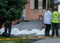 Kenyan police detectives stand next to the bodies of victims of a deadly fire at the Utumishi Girls Academy in Gilgil, north of the capital Nairobi on May 28, 2026. Photo: AFP
