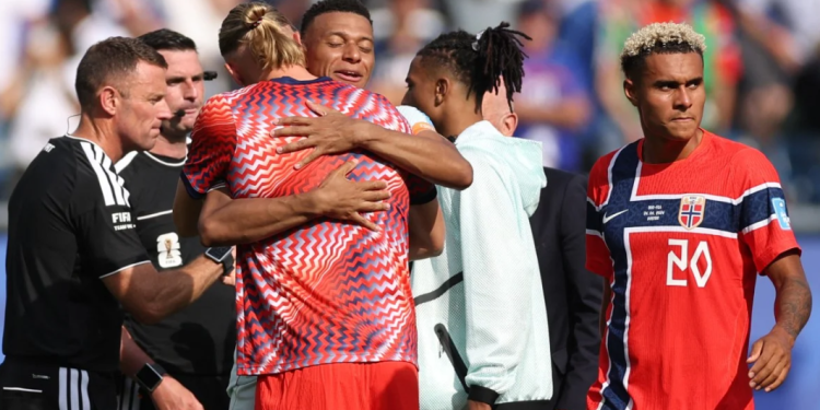 Norway's forward #09 Erling Braut Haaland hugs France's forward #10 Kylian Mbappe at the end of the 2026 World Cup Group I football match between Norway and France at the Boston Stadium in Foxborough on June 26, 2026