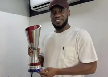 Austin Okocha displaying is award in recognition of outstanding performance at 1998 World Cup in France.