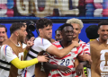 US forward #20 Folarin Balogun, C, celebrates scoring his team's third goal with teammates during the 2026 World Cup Group D football match between USA and Paraguay at the Los Angeles Stadium in Inglewood on June 12, 2026