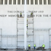 Workers stand on scaffolding near the signage for the Donald J. Trump and John F. Kennedy Memorial Center for the Performing Arts in Washington