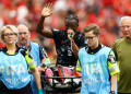 Canada’s Ismael Kone waves to the crowd as he uses a ‘green whistle’, Penthrox, a portable, self-administered inhaler used by paramedics for fast-acting pain relief, after sustaining an injury and being stretchered off