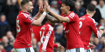 Manchester United's English defender, 23 Luke Shaw, L, celebrates with Manchester United's Argentinian defender, 06 Lisandro Martinez, R, after scoring the opening goal during the English Premier League football match between Manchester United and Nottingham Forest at Old Trafford in Manchester, northwest England, on May 17, 2026