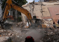 Workers clear debris from a collapsed building in Caracas, Venezuela