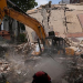 Workers clear debris from a collapsed building in Caracas, Venezuela