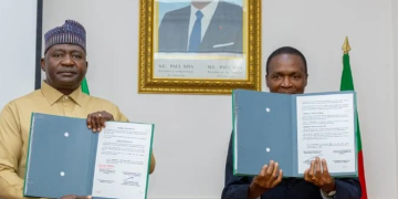Nigeria's Minister of Defense, General Christopher Musa, retd, and Cameroon's Minister Delegate at the Presidency in Charge of Defense, Mr. Joseph Assomo, after signing the MoU