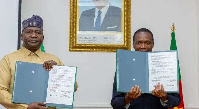 Nigeria's Minister of Defense, General Christopher Musa, retd, and Cameroon's Minister Delegate at the Presidency in Charge of Defense, Mr. Joseph Assomo, after signing the MoU