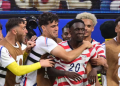 US forward #20 Folarin Balogun celebrates scoring his team's third goal with teammates during the 2026 World Cup Group D football match between USA and Paraguay