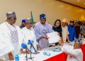 National Chairman of the APC, Prof. Nentawe Yilwatda recieves the formal submission of the duly completed nomination forms of Tinubu and Shettima