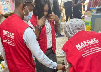 NAFDAC officials inspecting health products during a regulatory enforcement exercise aimed at protecting consumers from unsafe products.