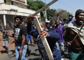 South Africans in Johannesburg carry sticks and traditional weapons during a protest amid the wave of xenophobic attacks targeting migrants, including Nigerians.