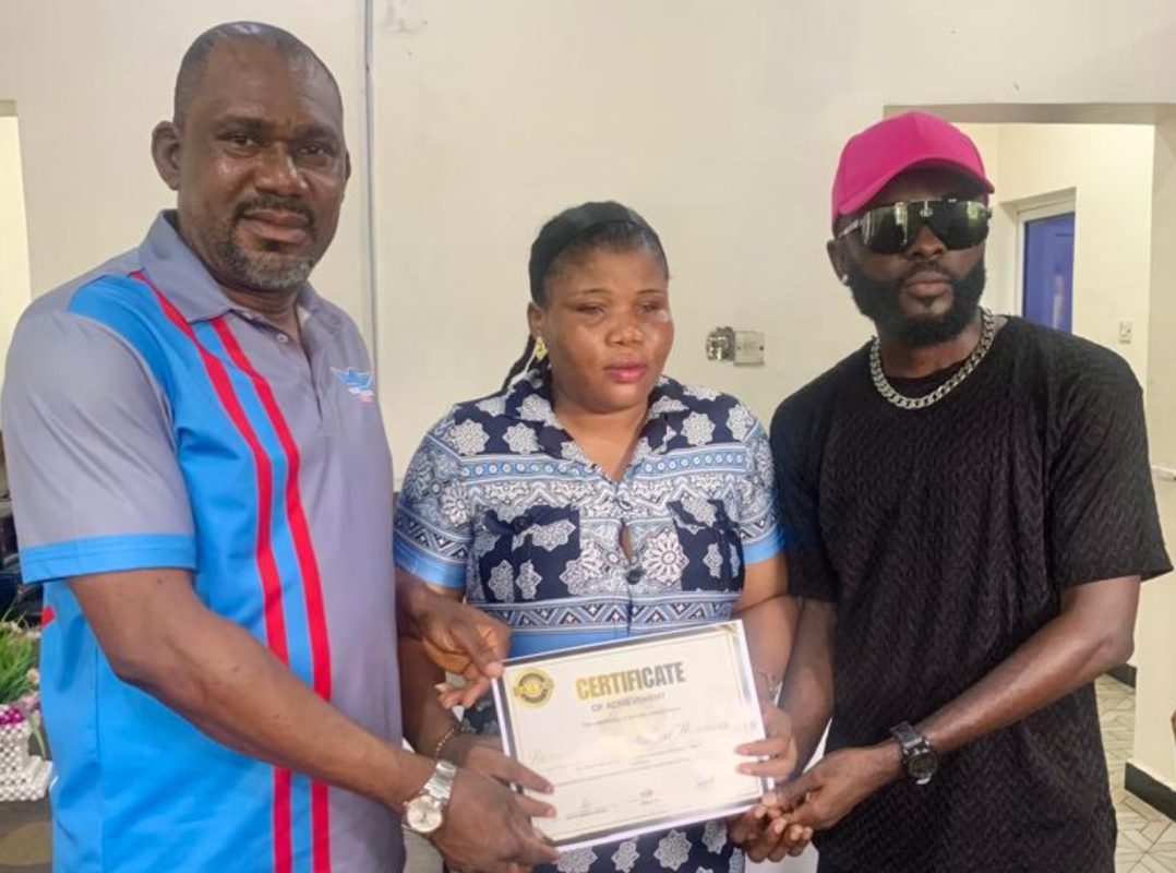 Sarima, middle, receives her award from UNA officials.