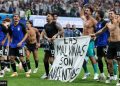 Argentine players display a banner making claims to Falklands Islands against FIFA rules.