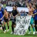 Argentine players display a banner making claims to Falklands Islands against FIFA rules.