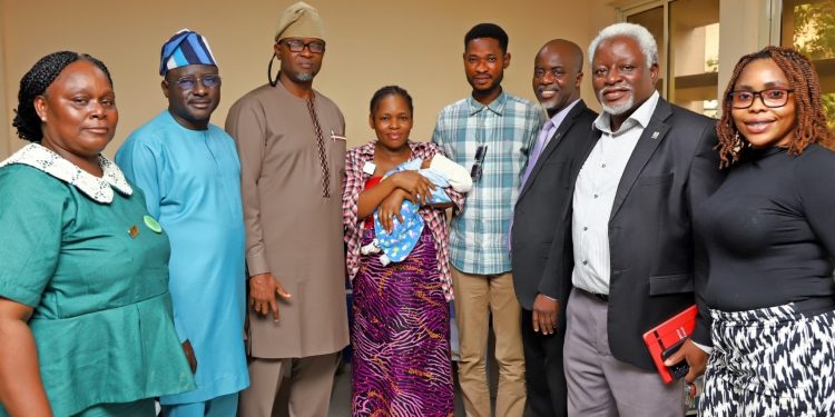 LUTH management staff celebrate with the Bolarindes after the delivery of a baby boy.