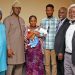 LUTH management staff celebrate with the Bolarindes after the delivery of a baby boy.