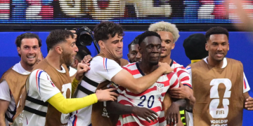 US forward #20 Folarin Balogun, C, celebrates scoring his team's third goal with teammates during the 2026 World Cup Group D football match between USA and Paraguay at the Los Angeles Stadium in Inglewood on June 12, 2026