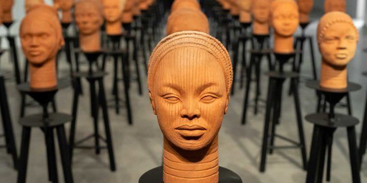 Art installation “Statues Also Breathe” by artist Prune Nourry features 108 unique terracotta heads inspired by ancient Nigerian Ife art, symbolizing the missing Chibok schoolgirls.