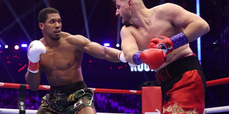 Former heavyweight champion Anthony Joshua battles Kristian Prenga during their bout in Jeddah, Saudi Arabia.