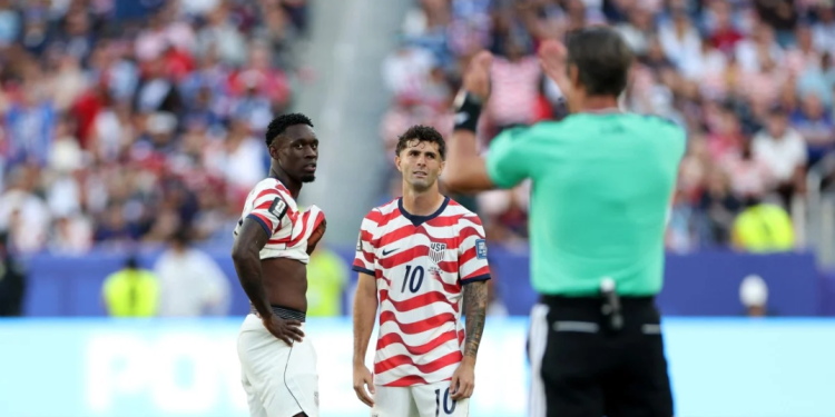 Balogun standing with Pulisic awaiting the ref verdict after a VAR check on an infraction