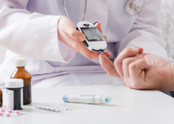A person checking blood sugar levels, highlighting diabetes as a recognised health risk linked to lifestyle and dietary choices.