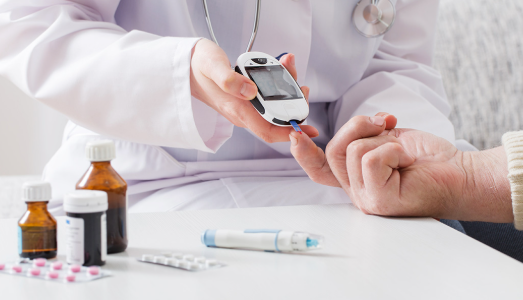 A person checking blood sugar levels, highlighting diabetes as a recognised health risk linked to lifestyle and dietary choices.