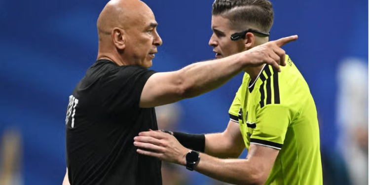 Egypt's head coach Hossam Hassan speaks with French referee Francois Letexier during the 2026 World Cup round of 16 football match between Argentina and Egypt at Atlanta Stadium in Atlanta on July 7, 2026