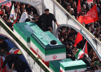 Crowds of mourners surround the convoy carrying the coffins of Iran’s slain supreme leader Ayatollah Ali Khamenei and members of his family during a funeral procession, before he is buried at the Shrine of Imam Reza, Iran’s most revered place of worship, in Mashhad on July 9, 2026.