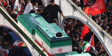 Crowds of mourners surround the convoy carrying the coffins of Iran’s slain supreme leader Ayatollah Ali Khamenei and members of his family during a funeral procession, before he is buried at the Shrine of Imam Reza, Iran’s most revered place of worship, in Mashhad on July 9, 2026.