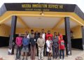 Twelve suspects arrested by the Nigeria Immigration Service stand outside the agency's Migrant Holding Centre