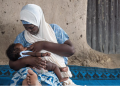 A woman breastfeeding her child