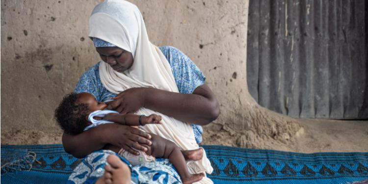 A woman breastfeeding her child