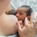 A mother breastfeeds her baby, highlighting the importance of exclusive breastfeeding as health authorities and families promote breast milk as the safest and most affordable source of nutrition for infants during World Breastfeeding Week.
