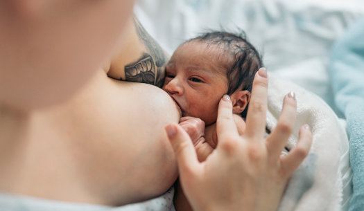 A mother breastfeeds her baby, highlighting the importance of exclusive breastfeeding as health authorities and families promote breast milk as the safest and most affordable source of nutrition for infants during World Breastfeeding Week.