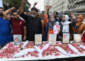 Human rights activists hold a candlelight vigil to mourn the deaths of newborns killed in a hospital fire in Pakistan this week